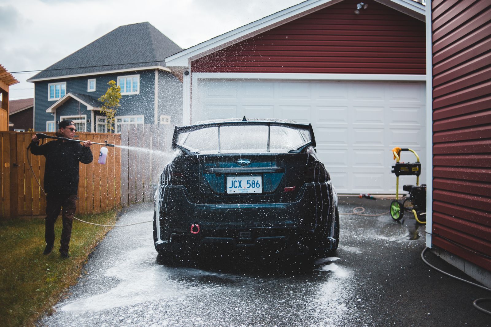 Pressure washer cleaning a concrete driveway